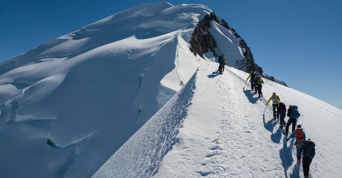 A hiker on a mountain ridge in the Swiss Alps