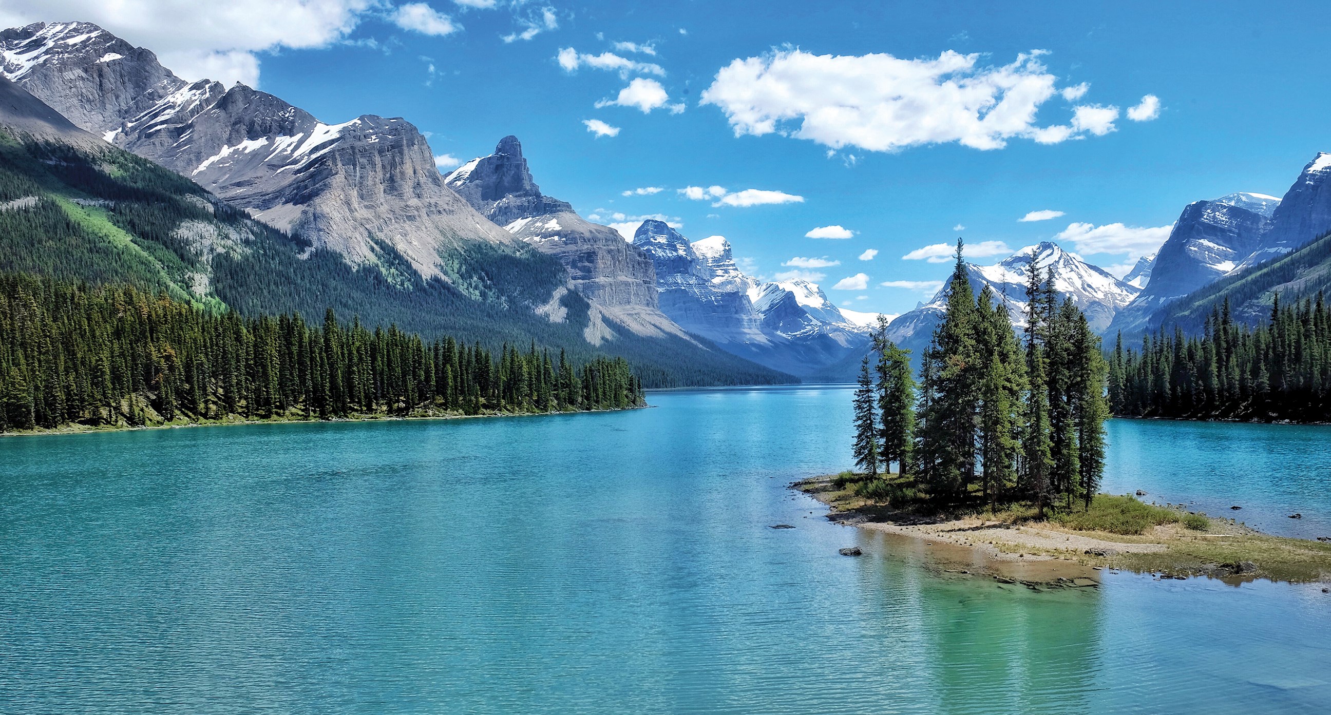 A deep blue lake surrounded by the Canadian Rocky Mountains